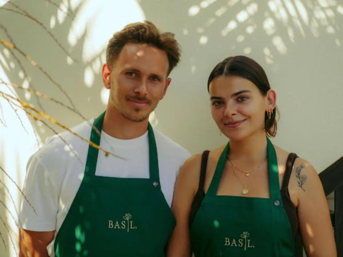 Raphael Hoetzel and Inês Crespo, the chefs behind Basil Algarve, in green Basil aprons