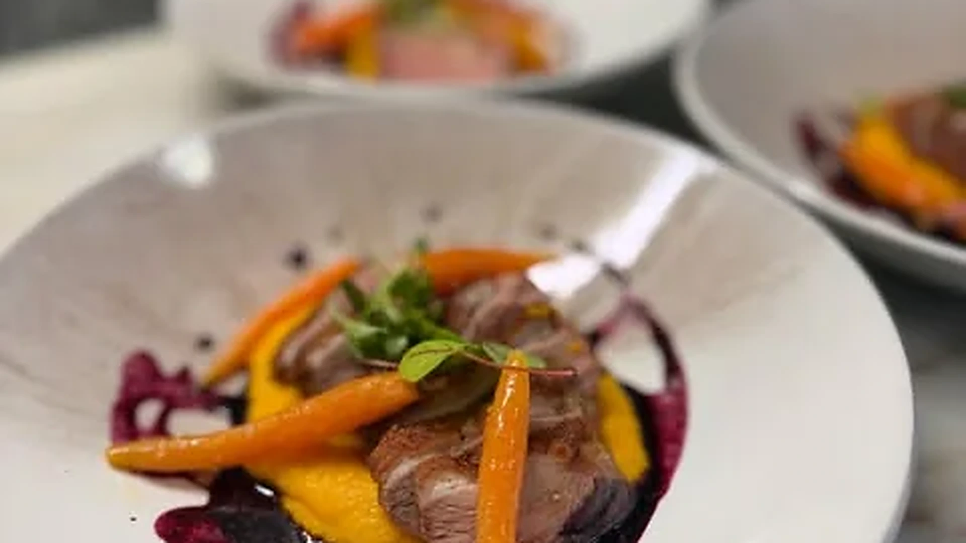 A chef plating a course during a private dinner service