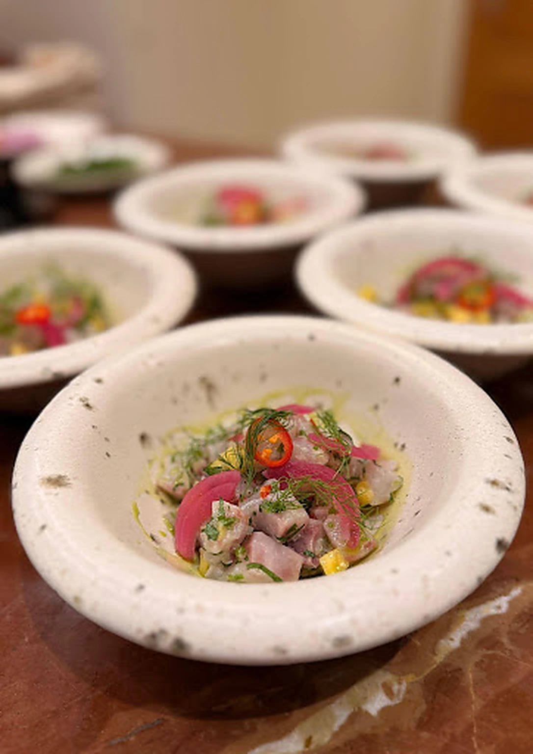 Individual bowls of colourful ceviche prepared for an Algarve event