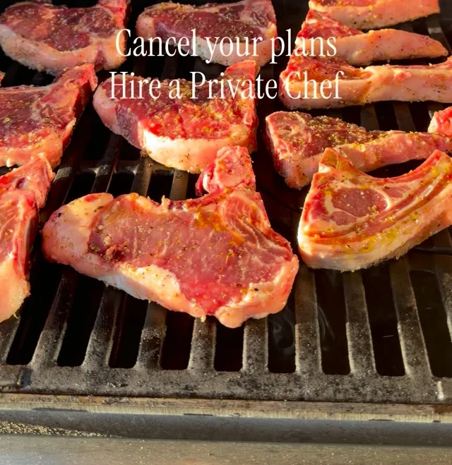 Pork chops searing on the bars of a charcoal grill