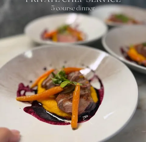 Plates of a five course private dinner lined up before service